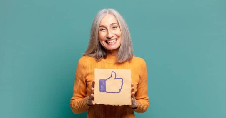 Craft & Communicate | Senior holding a facebook like button