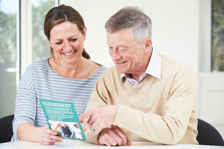 Craft & Communicate | Senior man and a family member looking at a brochure