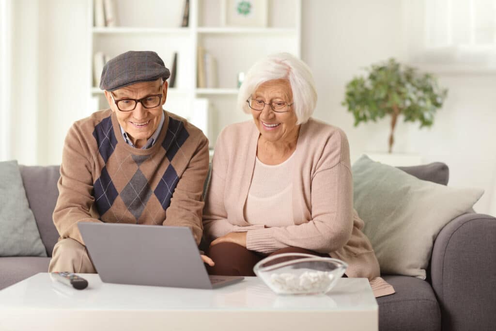 Craft & Communicate | Senior couple looking at a computer and smiling