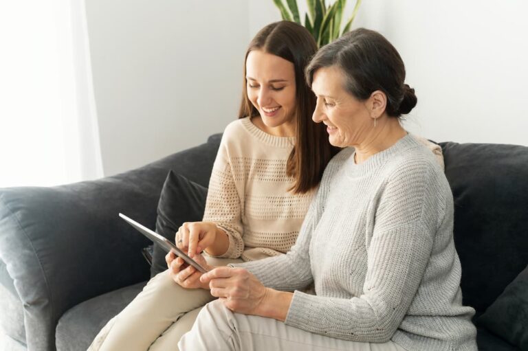 Craft & Communicate | Adult child with senior parent looking at tablet