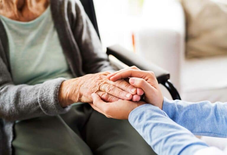 Craft & Communicate | Caregiver holding seniors hands